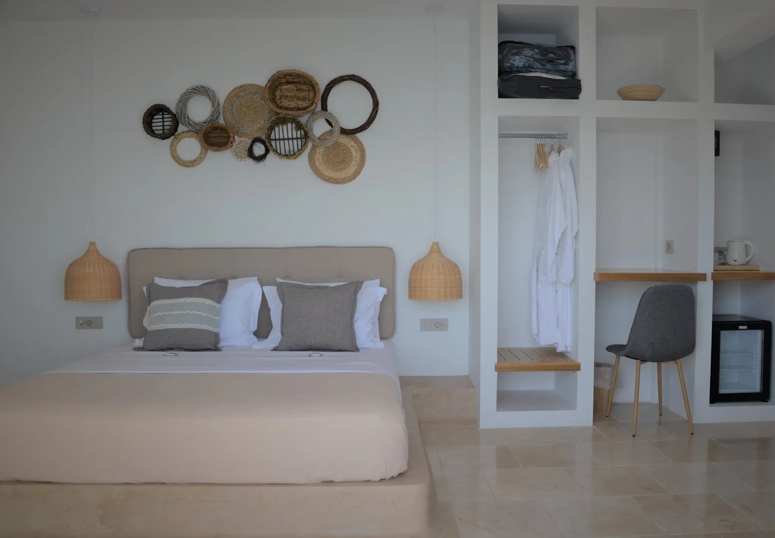Kaikzas bedroom with woven wall decor and open wardrobe