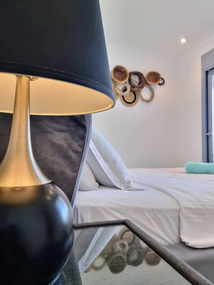 Table lamp and woven decor beside the Eos bed