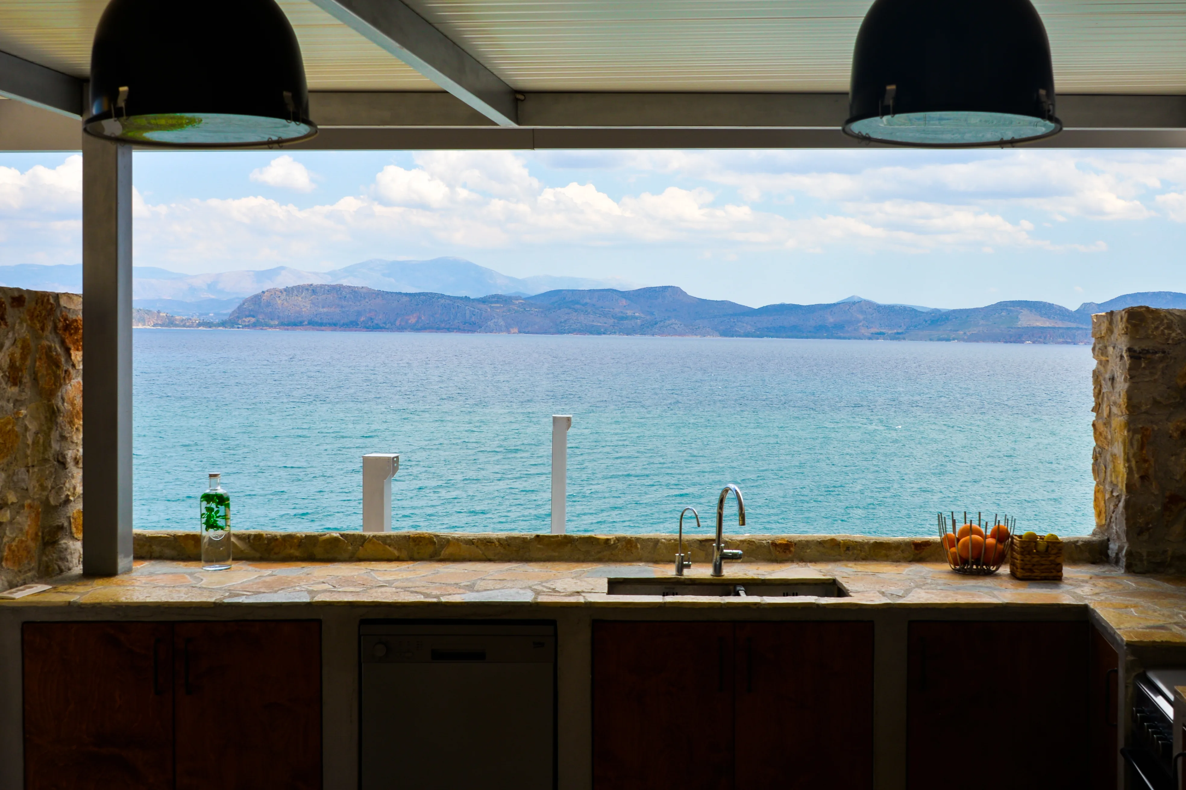 Outdoor kitchen counter with the gulf and mountains beyond