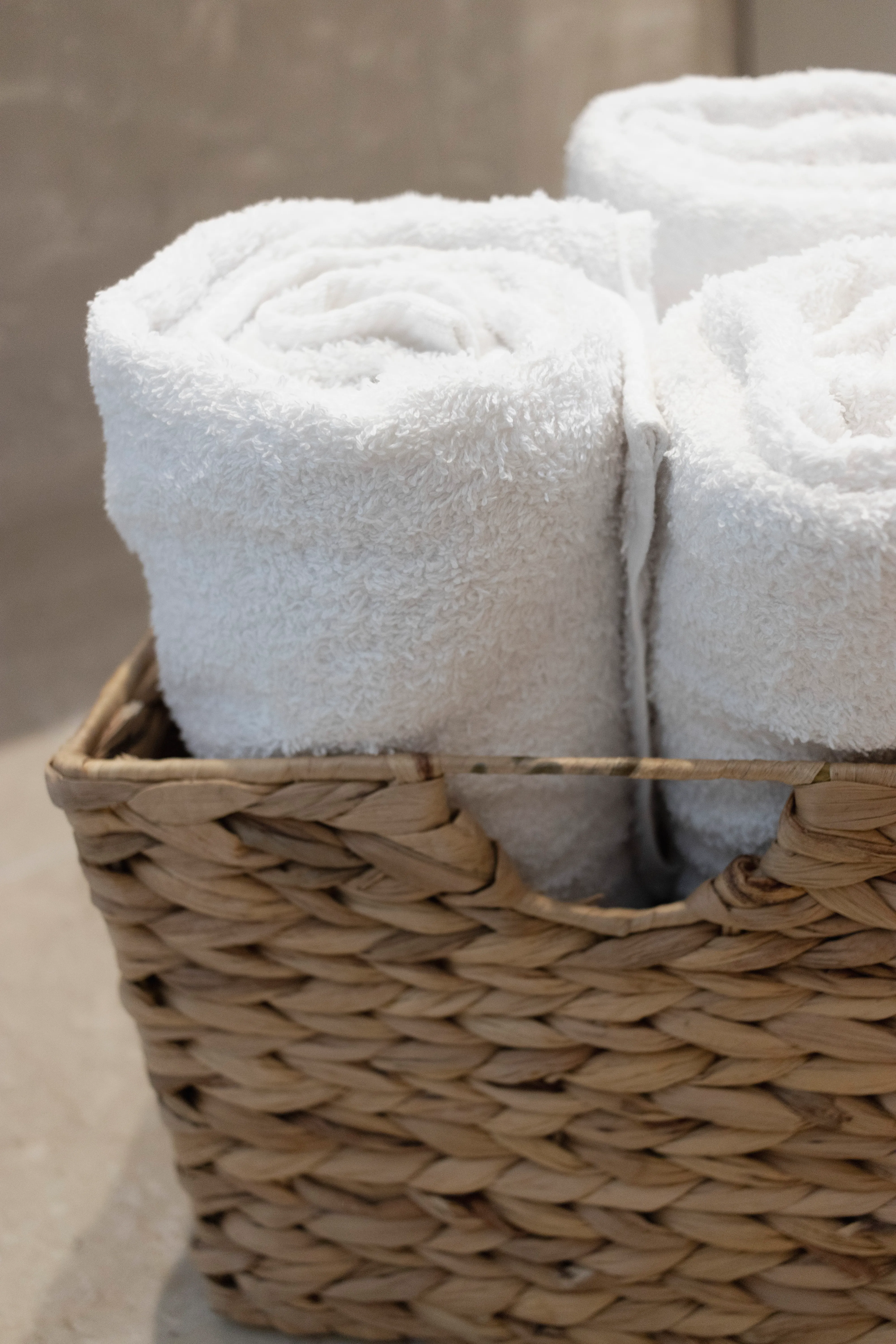 White towels rolled in a woven basket